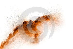 Brown dust exploding cloud.Brown particles splattered on white background