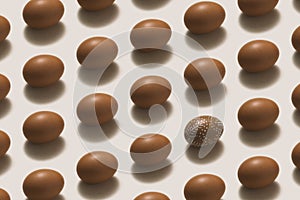 White painted Easter egg among brown easter eggs