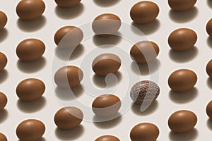 White painted Easter egg among brown easter eggs