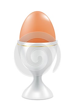 Brown egg in cup. Easter breakfast food.