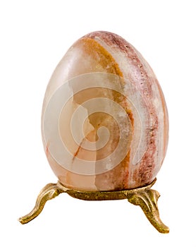 Brown egg made from onyx stone, close up, isolated