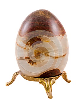 Brown egg made from onyx stone, close up, isolated