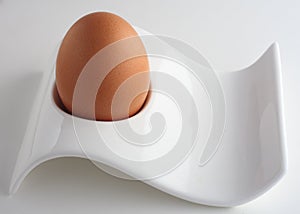 Brown egg in modernist eggcup