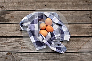 Brown eggs in a blue and white checked napkin