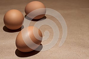Brown eggs on the brown paper rustic background