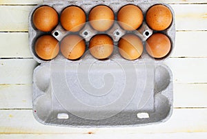 Brown eggs in a cardboard box. Fresh organic chicken eggs in carton or egg container with copy space Close-up view of