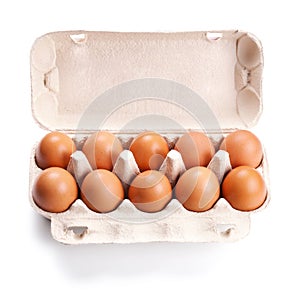 Brown eggs in a carton box on white