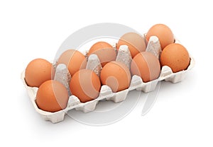Brown eggs in egg box on white background