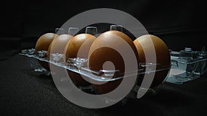 Brown eggs in a hard plastic box