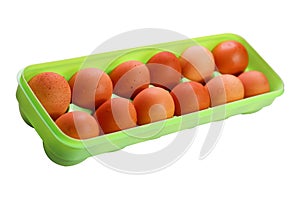Brown eggs in a plastic box isolated on a white background