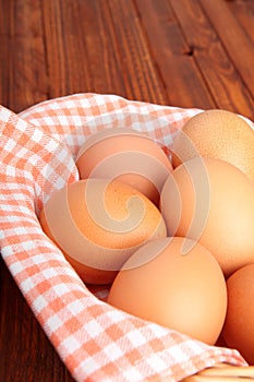 Brown eggs on the vintage cloth in the basket