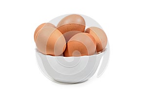 Brown eggs in white porcelan bowl isolated. Clipping path