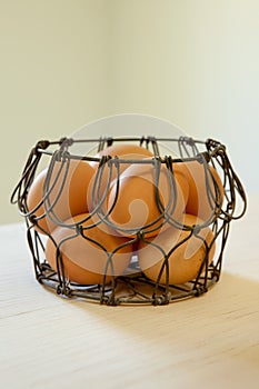 Brown eggs in a wire basket