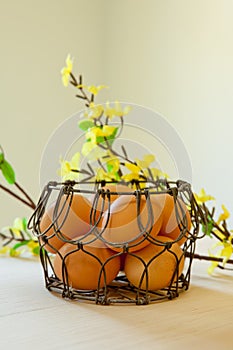 Brown eggs in a wire basket