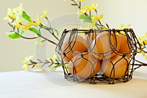 Brown eggs in a wire basket