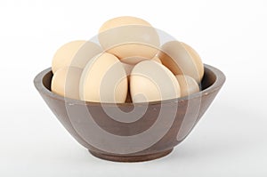 Brown eggs in a wooden bowl