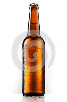Brown entire bottle of beer with drops isolated on white