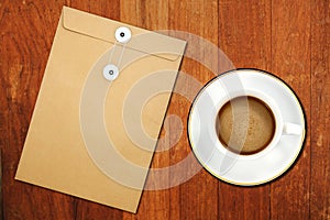 Brown Envelope document and a white coffee cup