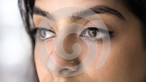 Brown eyes of young 20s Indian woman with extensional eyelashes