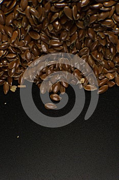 Brown Flax seed. Also known as Linseed, Flaxseed and Common Flax. Closeup of grains, background use