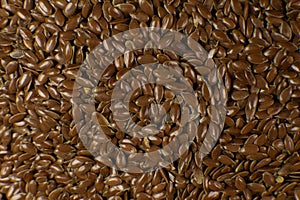 Brown Flax seed. Also known as Linseed, Flaxseed and Common Flax. Closeup of grains, background use