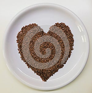 Brown flaxseeds in the form of the heart