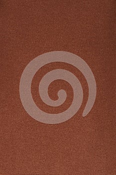 Brown fleece fabric. The texture of the fleece is gray. The background is fleece.