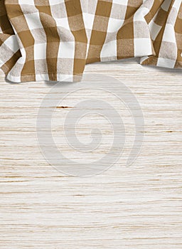 Brown folded tablecloth over oak bleached wooden table photo