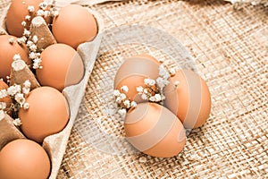 Brown fresh hen`s eggs on textile. photo