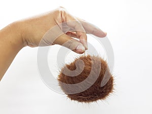 Brown fur ball woman cosmetics jewelry hair in white isolated background