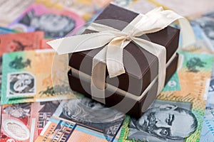 Brown gift box on australian dollar background