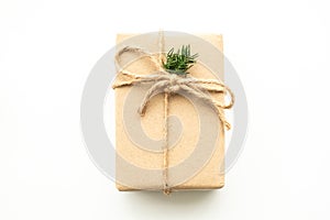 Brown gift box with festive decoration for Christmas and new year is on white background. Top view with copy space, flat lay