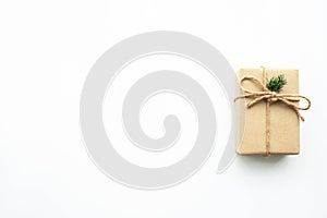 Brown gift box with festive decoration for Christmas and new year is on white background. Top view with copy space, flat lay