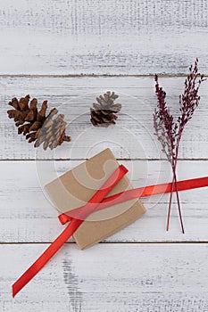 Brown gift box, pinecones and violet dried flower bouquet