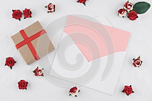 Brown gift box and pink card in white envelop
