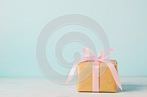 Brown gift box with pink ribbon bow