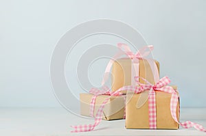 Brown gift box with pink ribbon bow