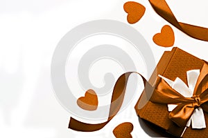 Brown gift box with ribbon and hearts on a white background, isolated image