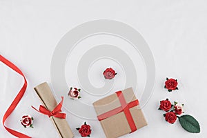 Brown gift box and scroll decorate with red rose paper flowers