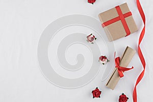 Brown gift box and scroll decorate with red rose paper flowers