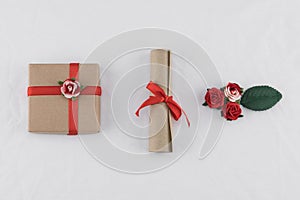 Brown gift box and scroll decorate with red rose paper flowers