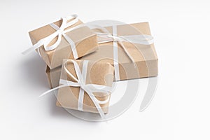 Brown gift box tied with white ribbon on clear background