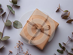 A brown gift wrapped with twine and leaves