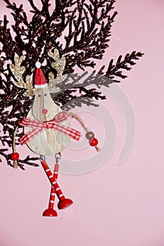 Brown gilded branch and deer in santa hat on a pink background for Christmas blank