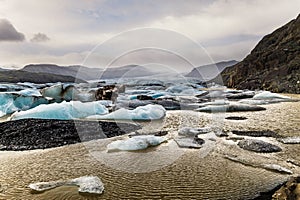 Brown Glacial waters ripple under the wind in Iceland