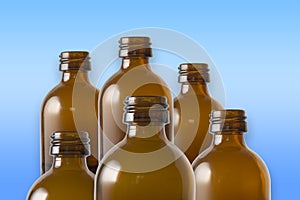 Brown glass bottles on a row. The rustic and vintage jars are clean. They look like old medicin keepings.