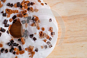 Brown glazed donut on wooden background