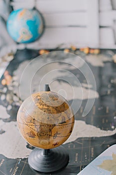 Brown globe on world map with blurred background