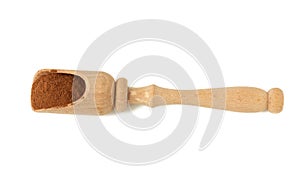 Brown ground cinnamon in a wooden spoon