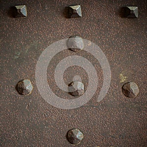 Brown grunge metal plate or armour texture with rivets